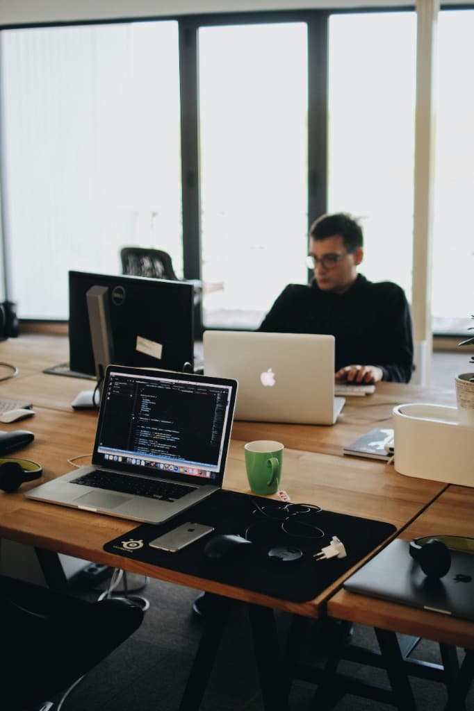 Professional workspace with multi-screen setup and natural light