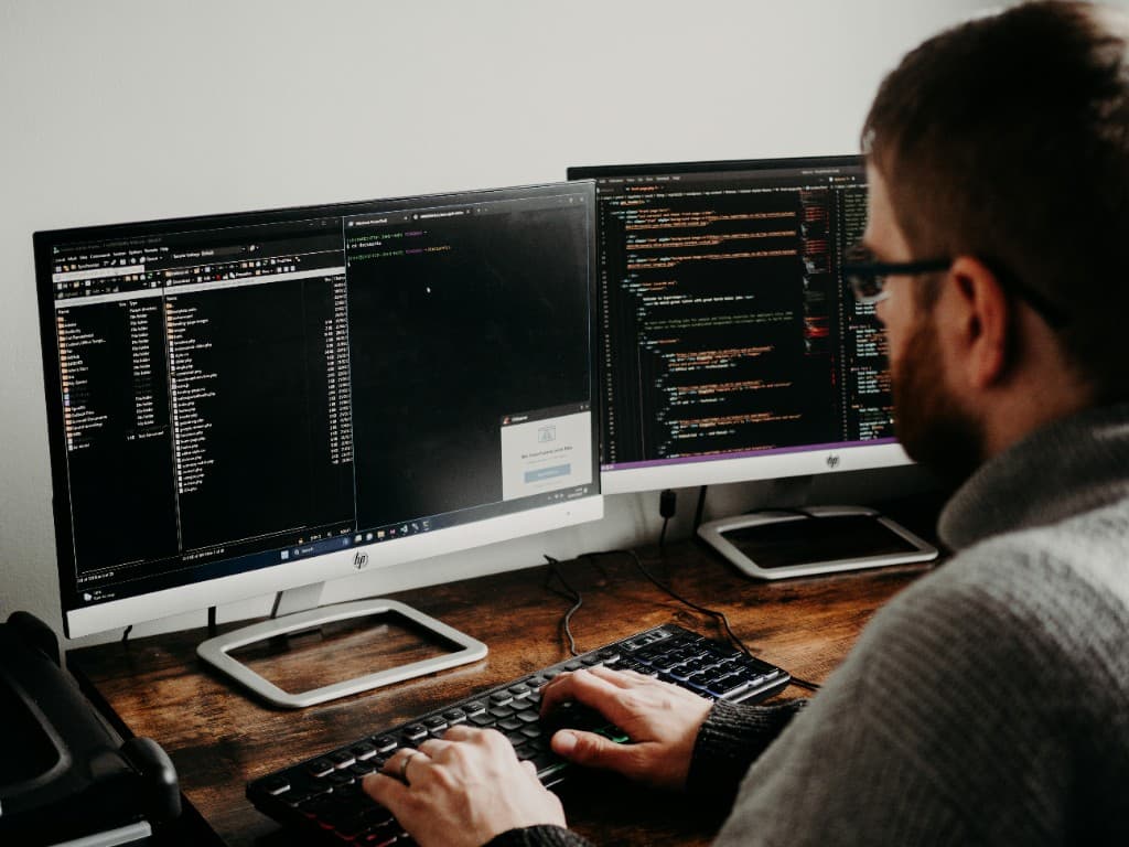 Overhead view of dual-monitor development environment